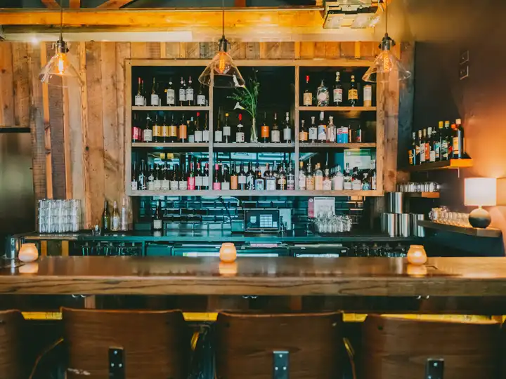 Dark wood wine bar interior with backlit wine bottles at Eduardo's Enoteca Gold Coast